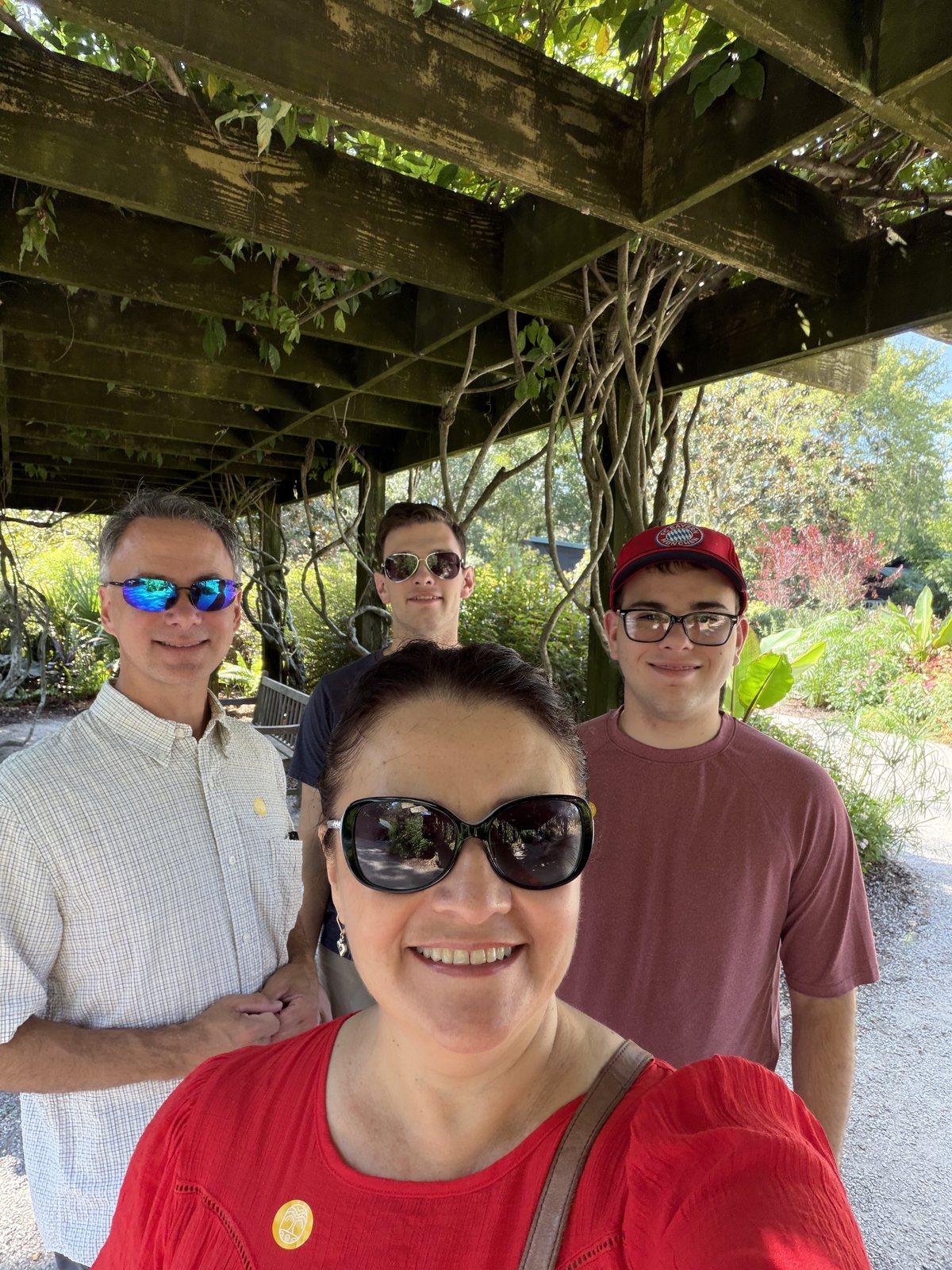 Under the arbor at the entrance. Sunglasses on, humidity at 100%.