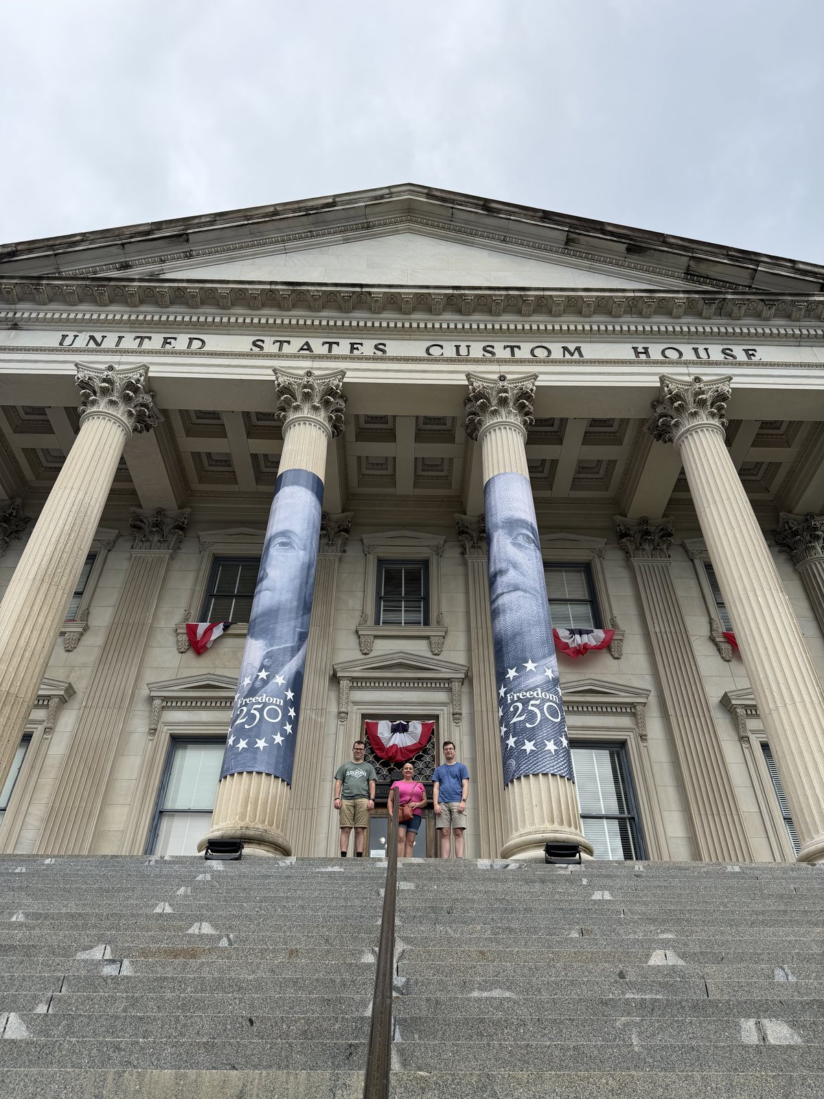 Freedom 250 banners on the columns — America's 250th, coming up next summer. Mommy and the boys are up at the top of the stairs.