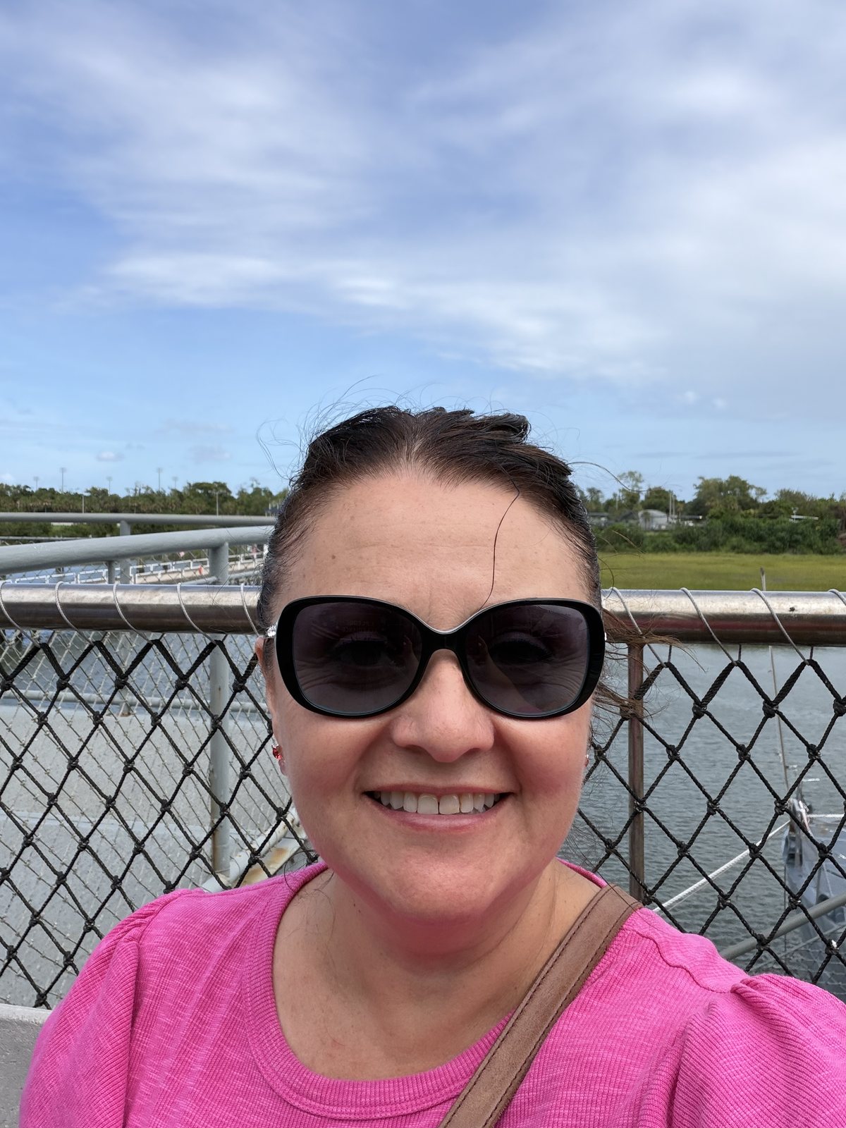 Mommy on the pier, 2:58pm, still smiling after four hours of ship.