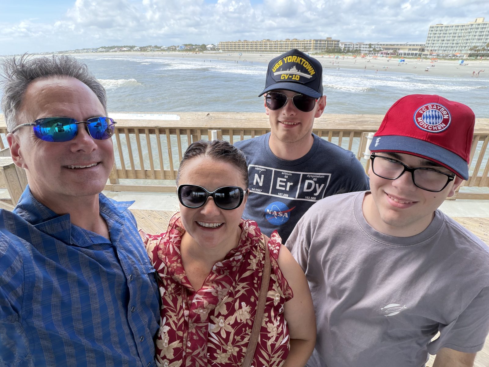 All four at the pier, the Atlantic behind.