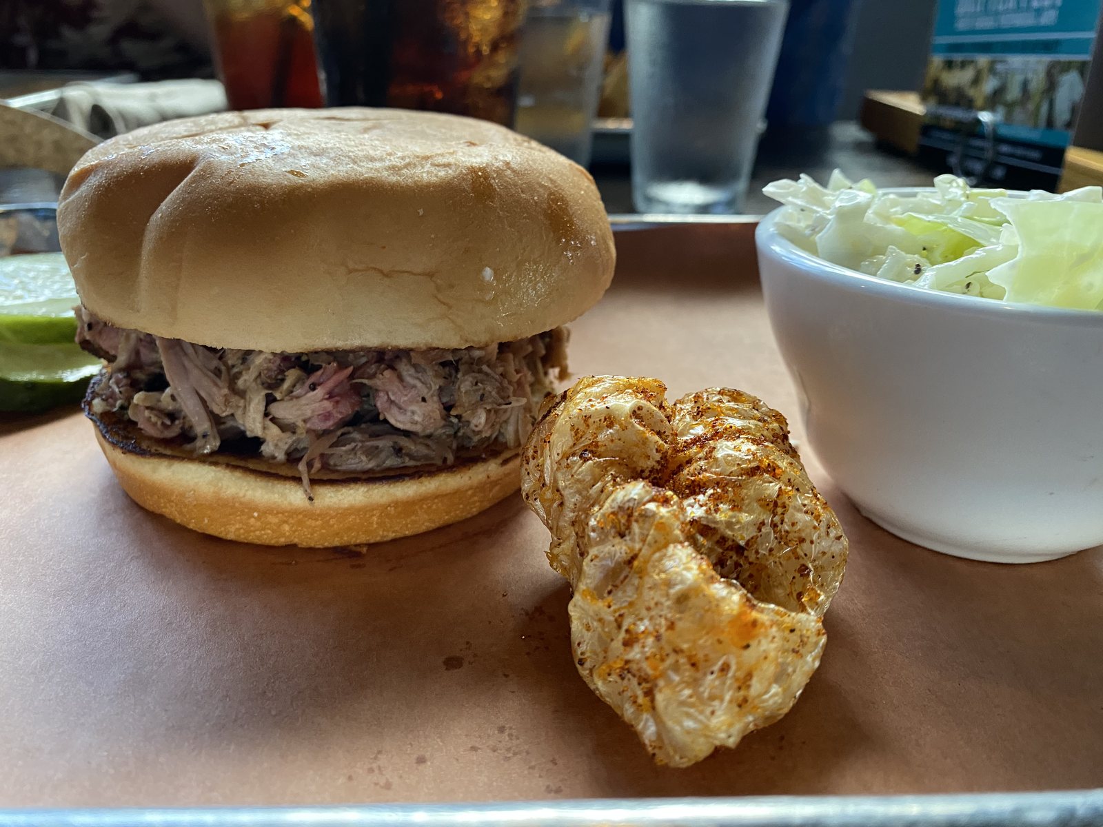 Pulled pork sandwich and chicharrón. Fried pork skin: identified, approved, gone.