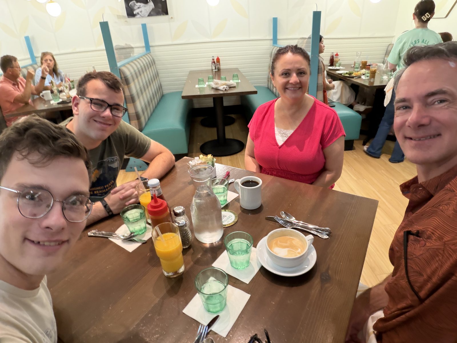 Millers All Day, round two. Teal booths, orange juice, four menus we'd already read.
