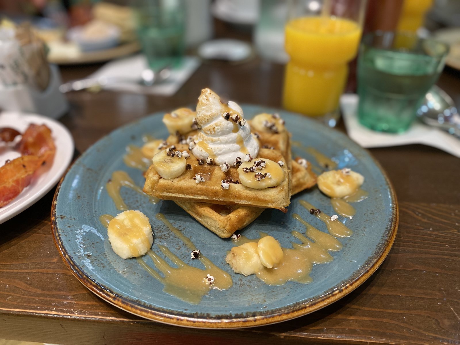 That waffle did not stand a chance. Bananas, caramel, bacon on the side.