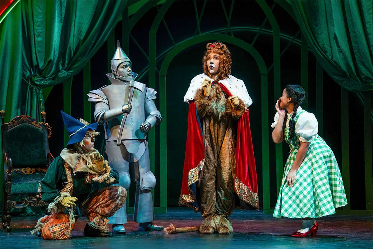 Tin Man, Lion, Dorothy, Scarecrow — and in the basket, Toto, the actual star of the show. Real name Cosmo. Photo: Charleston Stage